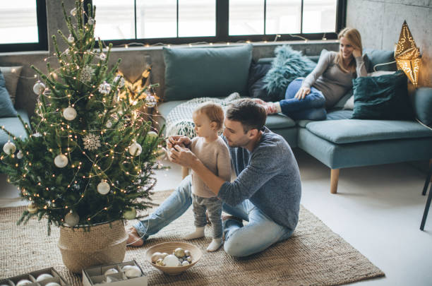 Father and daughter decorate a christmas tree | Shans Carpets And Fine Flooring Inc