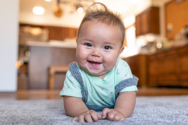 Baby lying on rug floor | Shans Carpets And Fine Flooring Inc