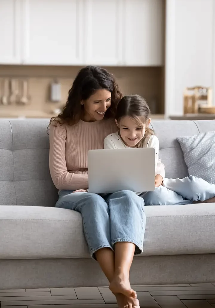 Mom and daugther writing a review on the computer | Shans Carpets